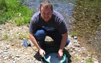 Biogeochemist Keith Morrison sieves antibacterial blue clay in the Oregon Cascades.